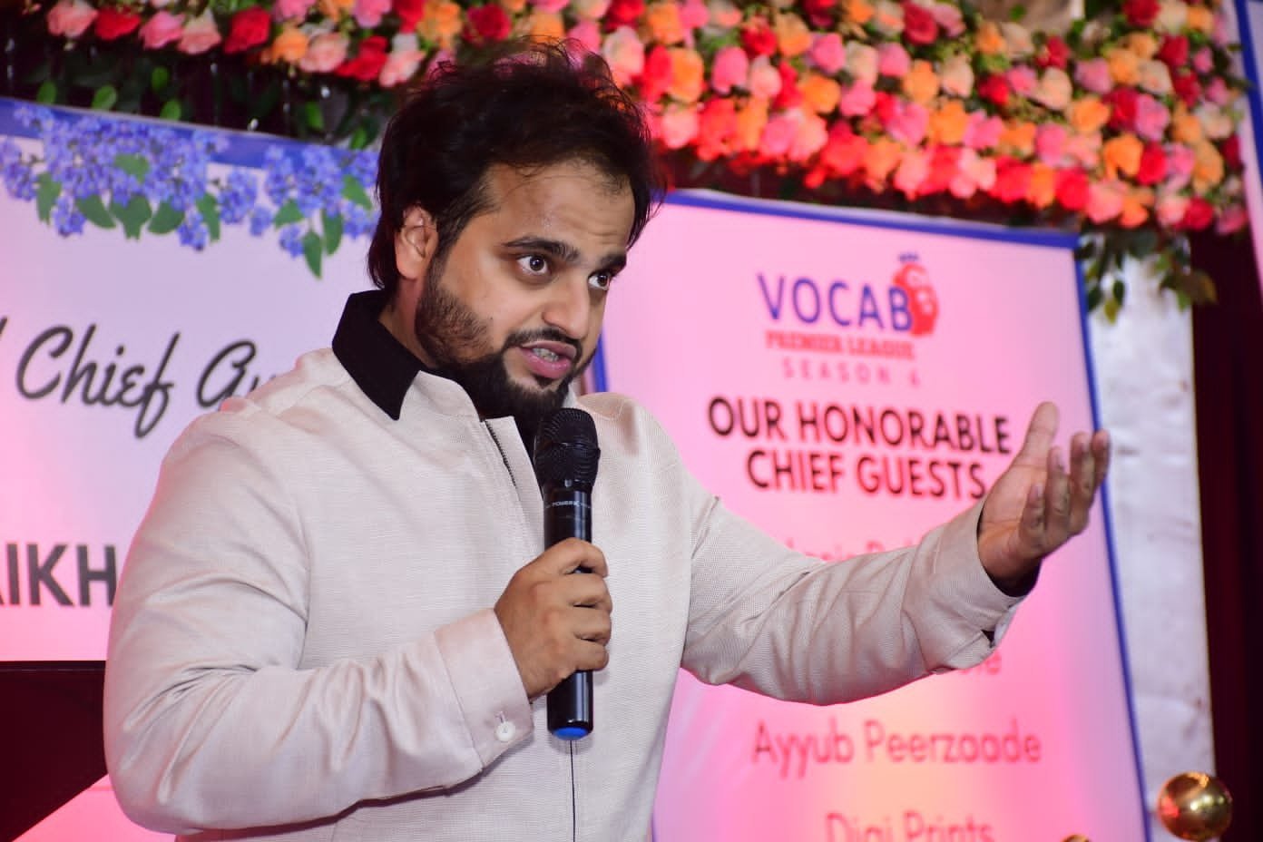 Maaz Rafique Shaikh speaking into a microphone